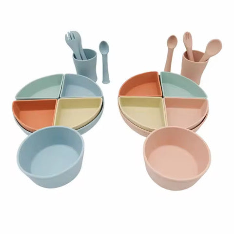 Complete silicone weaning set with suction plate, bowl, open cup, spoon and fork in blue and green colours.