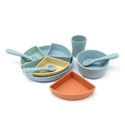 Pastel blue and green silicone feeding set showing open cup and divided suction plate for toddlers.