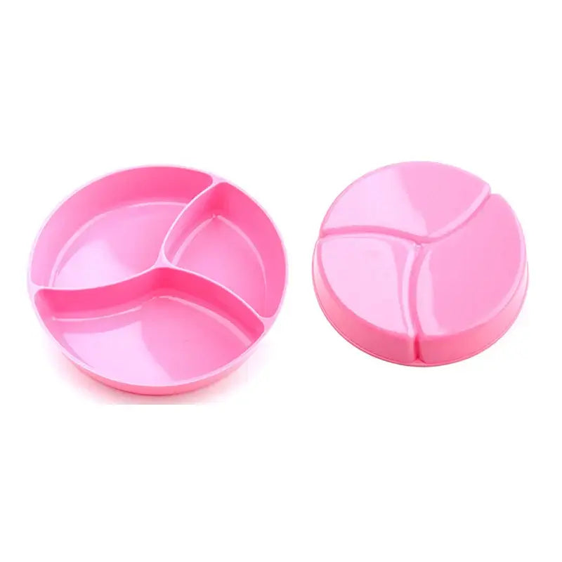 Pink suction bowl with three compartments for babies, designed to prevent spills during mealtime.